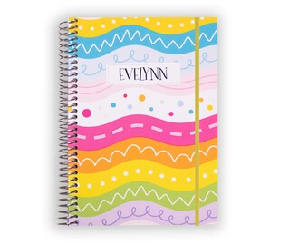 May include: A spiral-bound notebook featuring a colorful pattern of horizontal wavy lines in yellow, blue, pink, orange, and green. The cover includes white polka dots and scribbles, with the name EVELYNN printed in a central white rectangular box.
