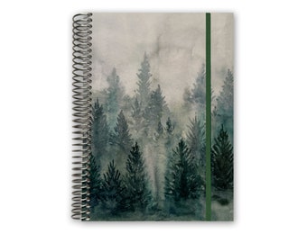 May include: A spiral bound notebook with a watercolor illustration of a misty forest scene. The cover features a green ribbon bookmark.