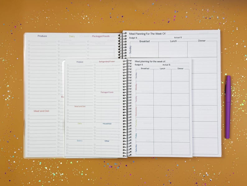 a planner with a pen on top of it