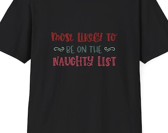 May include: Black t-shirt with the text "Most Likely To Be On The Naughty List" in red and green. The shirt is a crew neck style and appears to be made of cotton or a similar material. The text is in a decorative font.