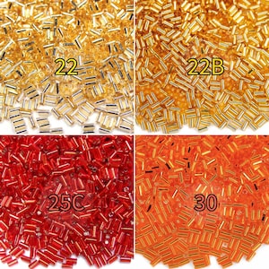 May include: Four sections of seed beads in gold, red, and orange hues. The top left section is gold with the number "22". The top right section is gold with "22B". The bottom left section is red with "25C". The bottom right section is orange with "30".