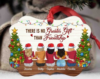 May include: A Christmas ornament with a woodgrain background and five women wearing Santa hats. The ornament reads "There is no greater gift than friendship." and includes the names Jessica, Betty, Sophie, Maddie, and Cecilia.