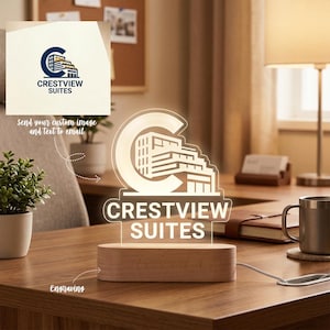 May include: A lit sign displaying "CRESTVIEW SUITES" in white, with a building design inside a "C" shape. It's mounted on a wooden base. The sign is illuminated, and the text "send your custom image and text to email" is also visible. The word "Engraving" is also visible.