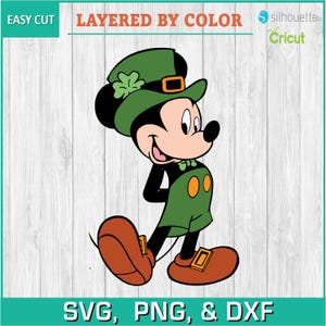 May include: Mickey Mouse dressed as a leprechaun wearing a green hat with a shamrock and a green and orange outfit. He is standing with his right hand on his hip and his left foot forward.