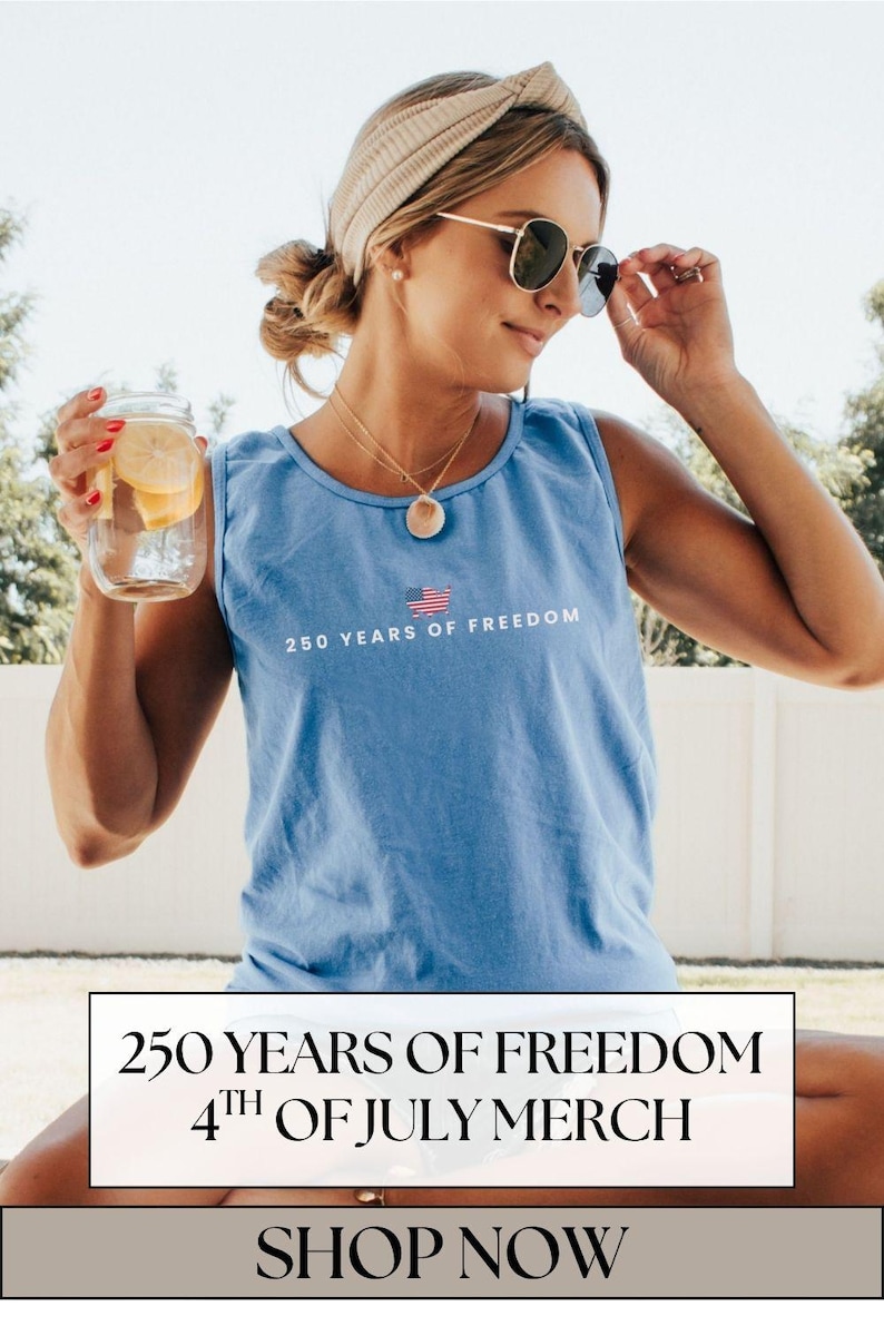 May include: A light blue tank top with the text "250 YEARS OF FREEDOM" and an American flag graphic. The image also includes a person wearing sunglasses and holding a glass jar with lemon slices.