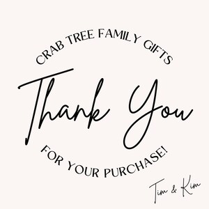 May include: A white card featuring black text that reads CRAB TREE FAMILY GIFTS in an arched font at the top, followed by the words Thank You in a large script font, and FOR YOUR PURCHASE! below. The name Tim & Kim is written in script at the bottom.