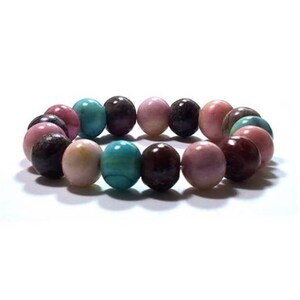 May include: A stretch bracelet composed of smooth, spherical beads in a variety of colors including shades of pink, dark brown, and bright turquoise. The beads are arranged in a circular pattern, creating a continuous loop of polished stone-like spheres.