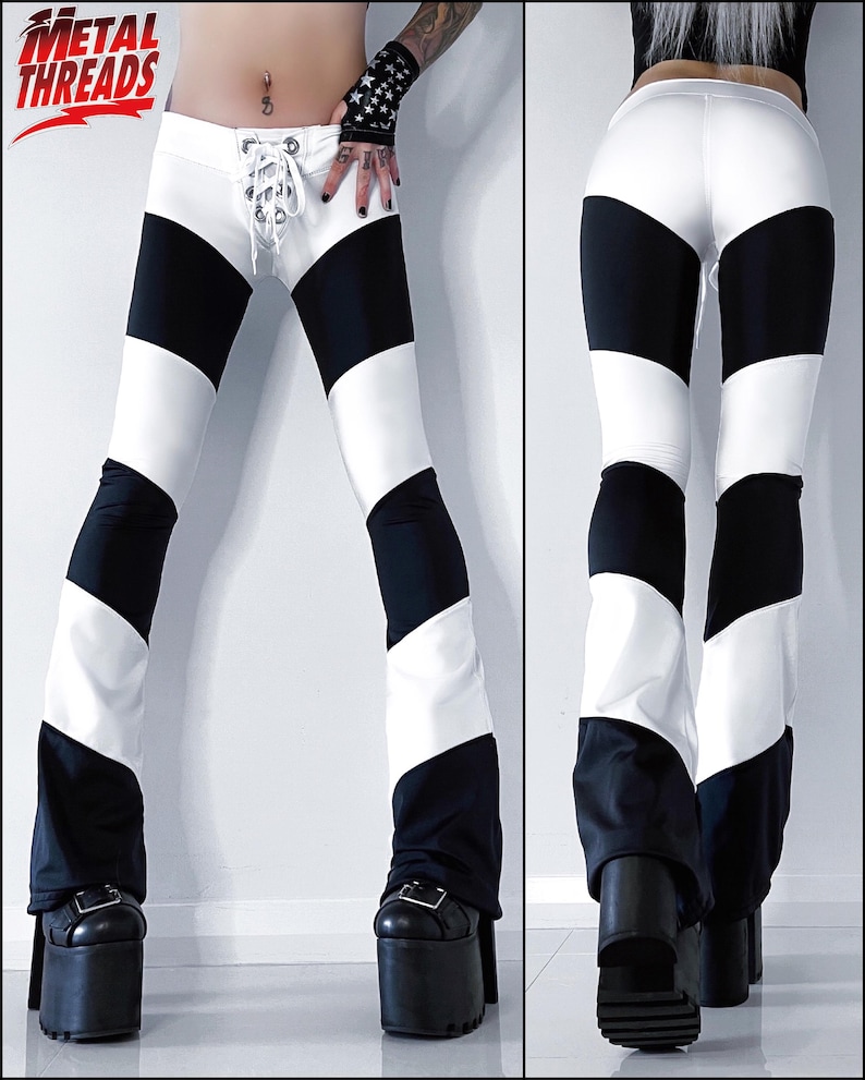 May include: Black and white striped pants with a lace-up detail at the front. The pants are flared at the bottom and have a high waist.