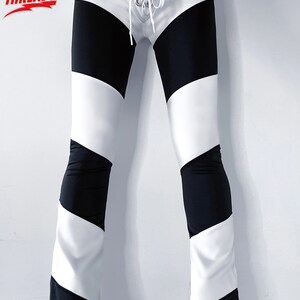 May include: Black and white striped pants with a white lace-up detail at the front.