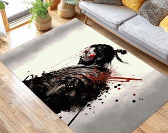 May include: Rectangular area rug featuring a stylized illustration of a samurai warrior. The artwork depicts the warrior with red accents on a light gray and off-white background. The rug is placed on a hardwood floor.