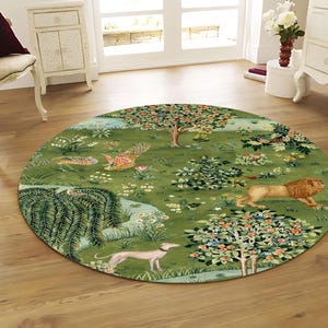 May include: A round green rug with a detailed pastoral scene featuring a lion, a greyhound, trees, and flowers. The rug has a detailed design with a variety of colors, including green, brown, and pink. The rug is placed on a wooden floor.