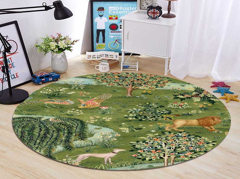 May include: Round green rug with a detailed illustration of a garden scene. The rug features trees, flowers, a lion, a dog, and birds. The rug is placed on a wooden floor.