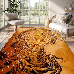 May include: Abstract art rug with a gold and brown color scheme. The rug features a swirling, textured design that resembles a face.