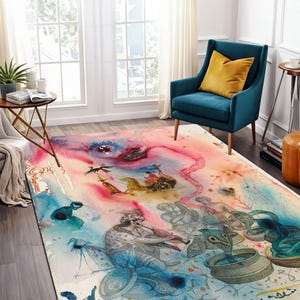Op de afbeelding: Een aquarelkleed met een kleurrijk abstract ontwerp met een groot oog, figuren en verschillende vormen. Het kleed heeft een lichtroze, blauwe en gele kleurstelling met een witte achtergrond.