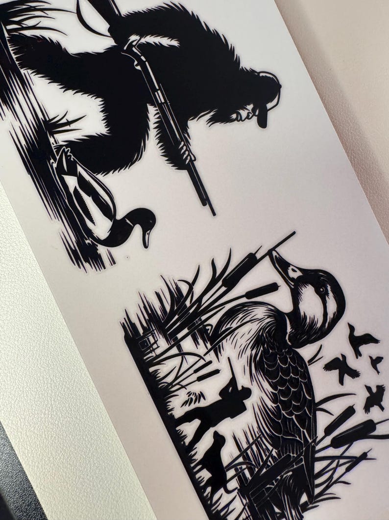 May include: Black and white illustration featuring a duck hunter with a dog, a duck, and a bigfoot-like creature with a rifle. The hunter is aiming at a duck in a marshy area. The bigfoot-like creature is also aiming a rifle.