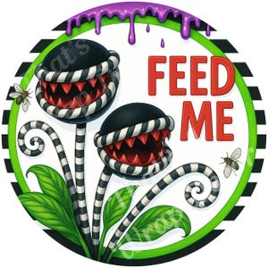 May include: A circular sign featuring two black and white striped carnivorous plants with red teeth and green leaves. The text FEED ME is printed in red. The background has black and white stripes with purple slime dripping from the top edge.