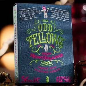 May include: A deck of playing cards with a dark blue background and green and pink text. The text reads "The Odd Fellows from New Orleans" and "Green Dye Playing Cards".