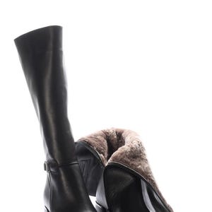 May include: Black leather knee-high boots with a block heel. One boot is upright, the other is partially folded down, revealing a warm, fur-like lining. The boots have a buckle detail near the ankle.