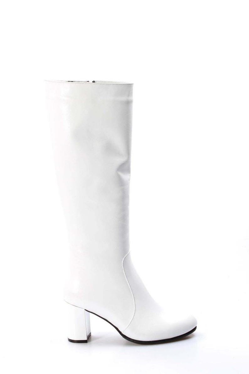 May include: White leather knee-high boots with a block heel.