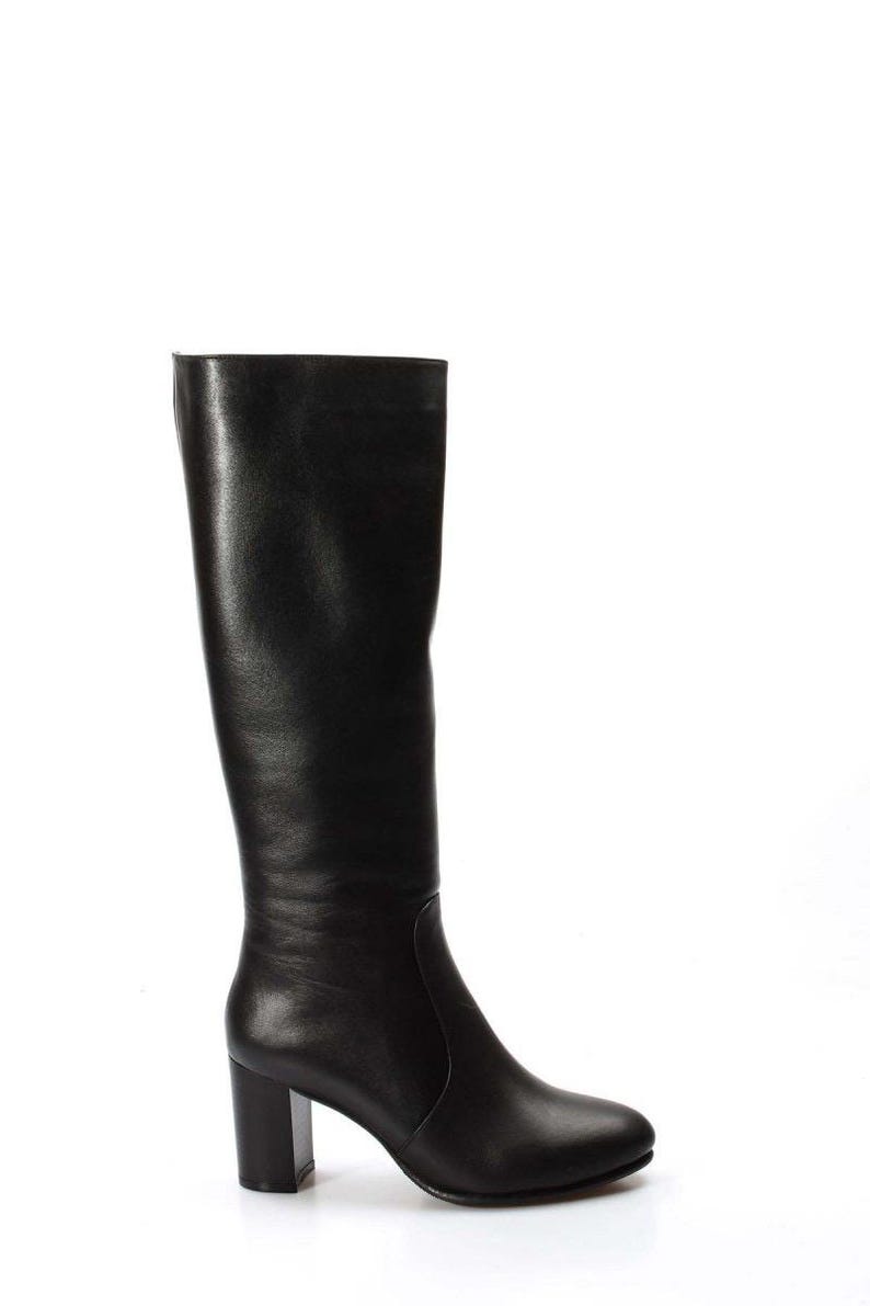 May include: Black leather knee-high boots with a block heel.