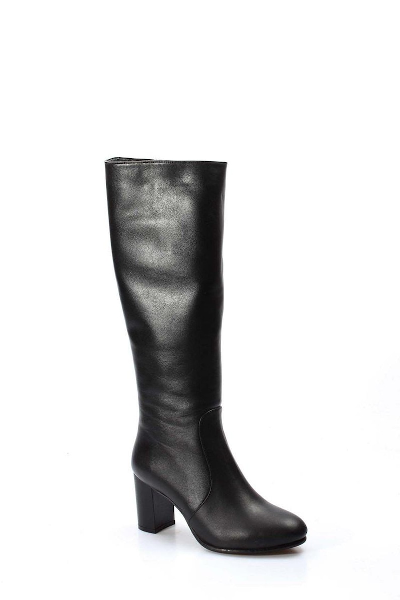 May include: Black leather knee-high boots with a block heel.