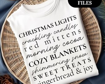 May include: White t-shirt with black text listing Christmas-themed words like "Christmas lights," "cozy blankets," and "gingerbread & joy." The shirt is on a woven tray with a pinecone and a blue cloth background. The text "PNG & SVG FILES" is in a black box.