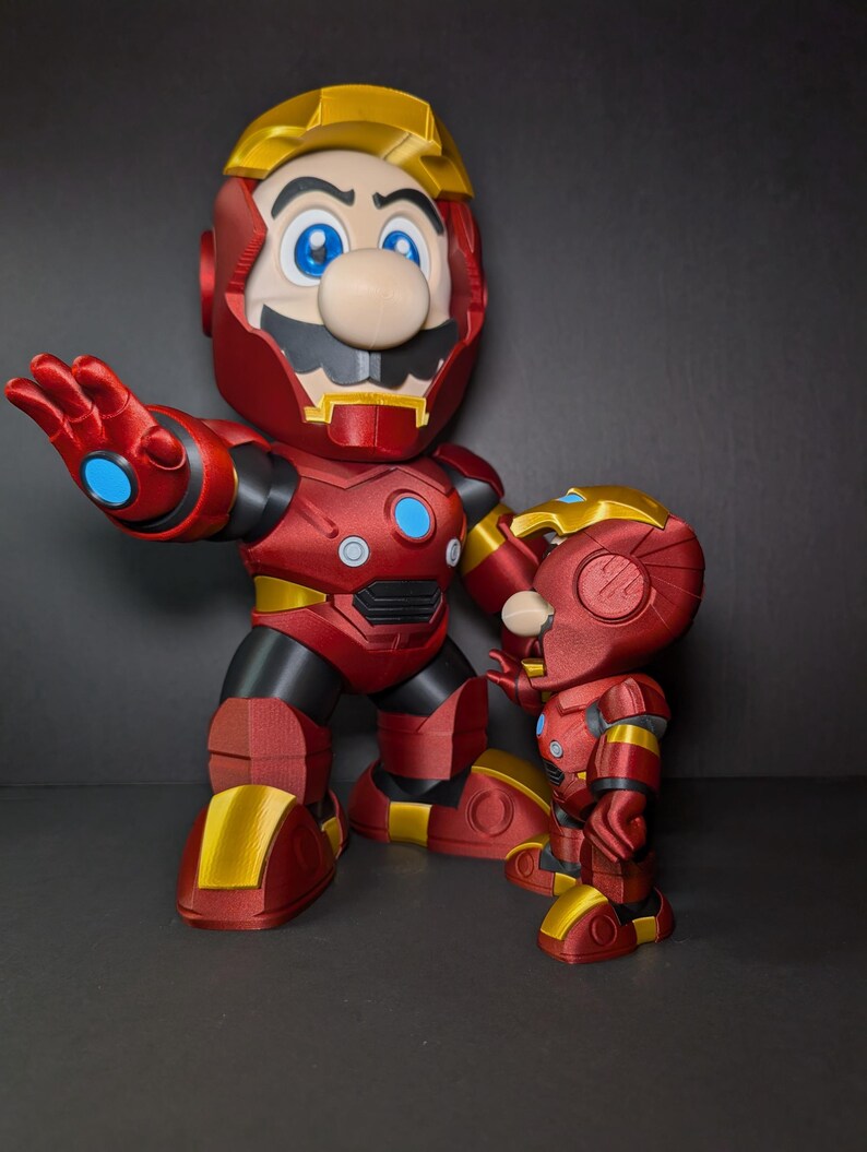 May include: Two red and gold action figures, one large and one small, resembling Mario in an Iron Man suit. The figures have blue eyes and a mustache. The larger figure is posed with an outstretched hand.
