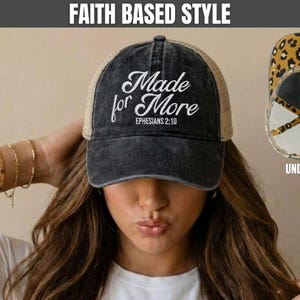 May include: A black distressed baseball cap with a mesh back, featuring the white text Made for More EPHESIANS 2:10 on the front. The underside of the brim displays a brown and black leopard print pattern, visible in the inset image on the right.