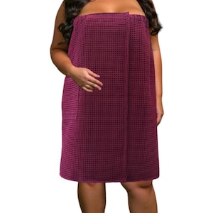 May include: A burgundy waffle weave bath wrap with a wrap-around style and a single pocket on the side.