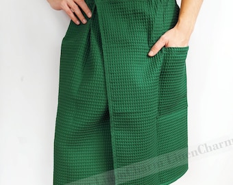 May include: A green waffle weave bathrobe wrap with a pocket on the side. The wrap is tied at the waist and has a long skirt.