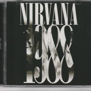 May include: A black and white CD case featuring the text NIRVANA at the top and the year 1988 in large, stylized white font. The design incorporates partial black and white photographic portraits of three individuals layered behind the text.