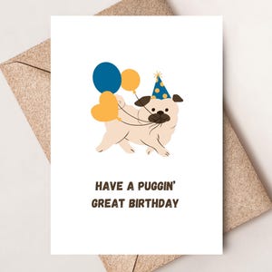 May include: A white greeting card featuring a tan pug wearing a blue party hat with yellow dots. The pug holds three balloons in blue, yellow, and orange. Below the illustration, the text reads: HAVE A PUGGIN' GREAT BIRTHDAY in dark brown letters.