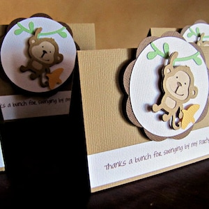 May include: Brown and white thank you cards with a monkey illustration and the text "Thanks a bunch for swinging by my party!"