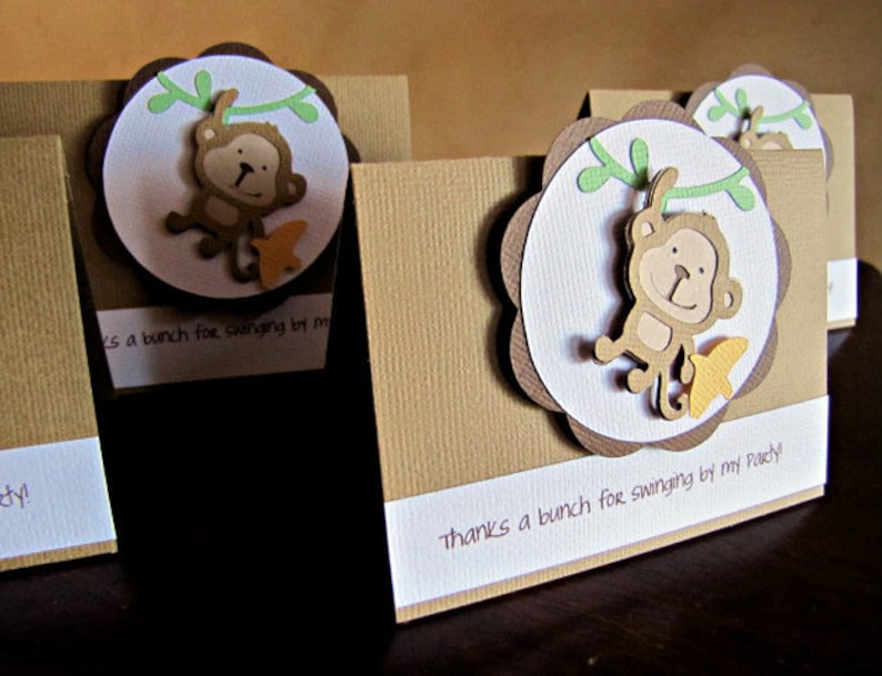 May include: Brown and white thank you cards with a monkey illustration and the text "Thanks a bunch for swinging by my party!"