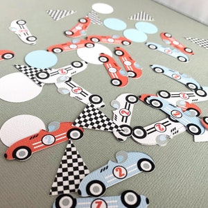 May include: A collection of red, blue, and white race car confetti. The confetti features checkered flags, circles, and race cars with the number 2 on them.