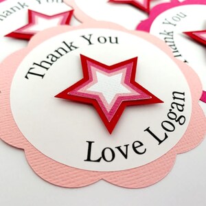 May include: Pink and red star-shaped thank you tags with the text "Thank You" and "Love Logan".