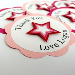 May include: Pink and white thank you tags with a red star and the text "Thank You Love Logan".