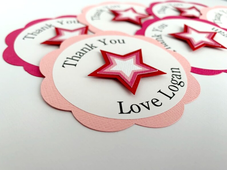 May include: Pink and white thank you tags with a red star and the text "Thank You Love Logan".