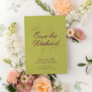 May include: A lime green invitation card with the text "Save the Weekend" in a cursive font, surrounded by floral illustrations. The card also includes names, a date, and a location. The background features an arrangement of flowers.