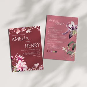 May include: Two wedding invitation cards. The main card is burgundy with floral accents and the names "AMELIA and HENRY". The second card, in a lighter shade, details reception, accommodation, and dress code information. Both cards feature floral designs.