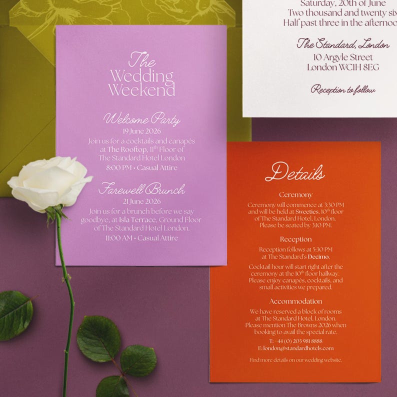 May include: A wedding invitation suite with a lavender card detailing the wedding weekend, an orange card with ceremony and reception details, and a white card with the date. A white rose is in the foreground.