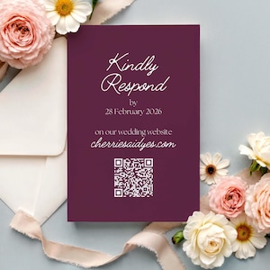 May include: A deep purple wedding invitation card with white calligraphy reading "Kindly Respond by 28 February 2026." The card also features a website address and a QR code. The card is decorated with flowers and an envelope.