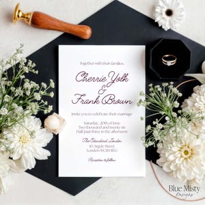 May include: A wedding invitation featuring the names Cherrie Yolk and Frank Brown, with white flowers and a black envelope. A gold ring in a black box and a wax seal are also visible. The invitation includes the date, time, and London venue.