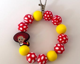 Toy Story Jessie Wristlet Keychain Bracelet Wearing in the Disneyland and Disney World Parks Pixie Dust Gifting and Everyday Wear