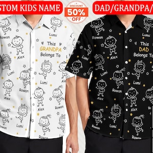 May include: Two button-down shirts, one white and one black, feature a repeating pattern of cartoon children and stars. The white shirt has the text "This Grandpa Belongs To" and the black shirt says "This Dad Belongs To".