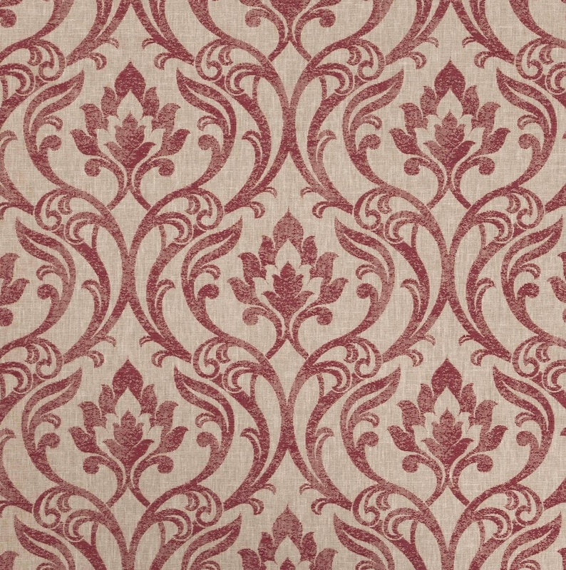 May include: A close-up of a fabric with a repeating damask pattern. The design features a light beige background with a deep red floral and scroll motif. The pattern is symmetrical, with stylized flowers and curved lines.