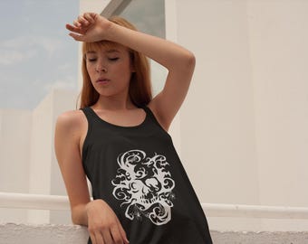 May include: Black tank top with a white skull design featuring bats, swirls, and spiderwebs. The sleeveless shirt is a casual garment, suitable for everyday wear. The design is centered on the front of the shirt.