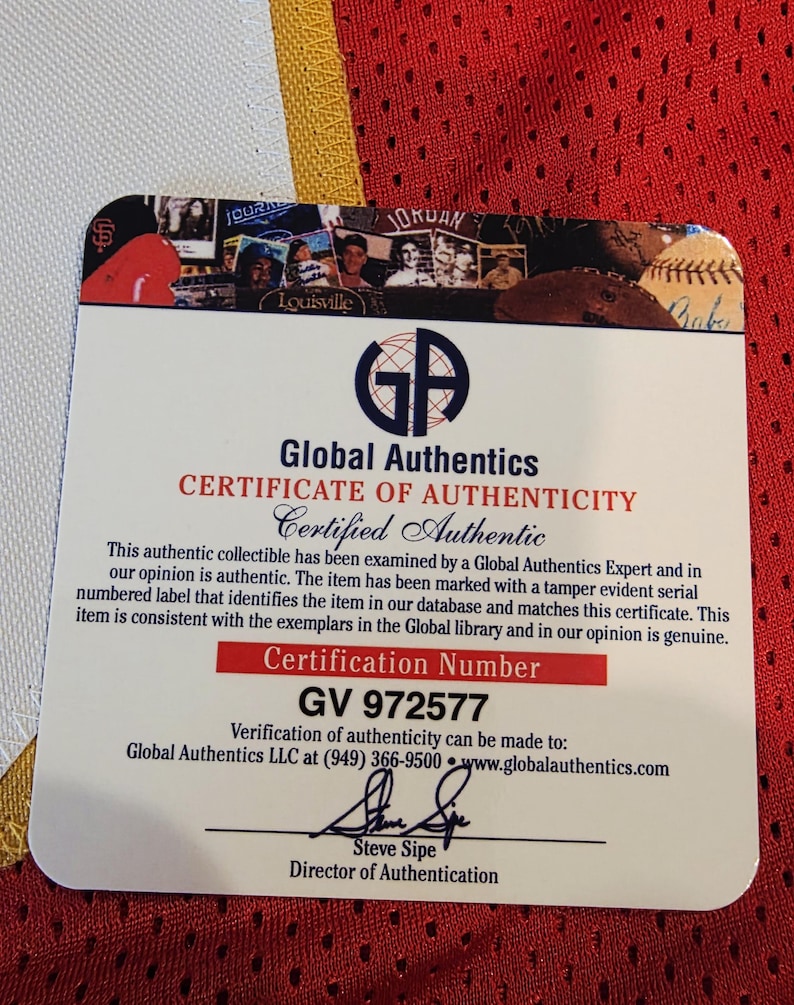 May include: A certificate of authenticity from Global Authentics, with the text "CERTIFICATE OF AUTHENTICITY Certified Authentic". The certificate includes the certification number GV 972577 and the signature of Steve Sipe, Director of Authentication.