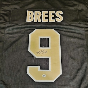 Camisa do New Orleans Saints assinada por Drew Brees, membro do Hall da Fama da NFL, com logotipo da equipe