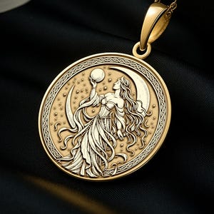 May include: A gold-colored pendant necklace featuring a detailed design of a woman holding a sphere and standing in front of a crescent moon. The pendant is round with an ornate border and hangs from a delicate chain. Orchids with white and purple petals are in the background.